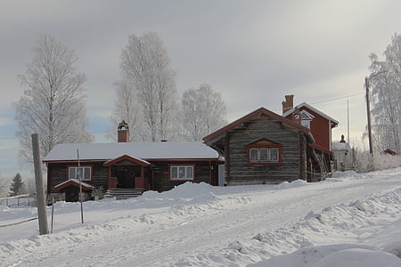 brown wooden house surrounded by snow thumbnail