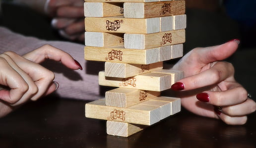 person playing jenga blocks thumbnail