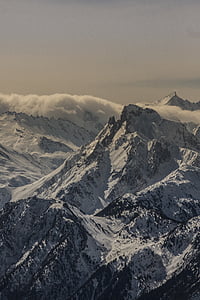 snow coated mountain at cloudy sky thumbnail