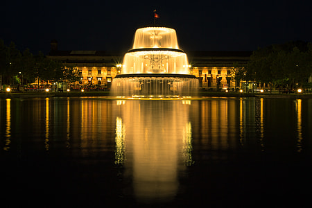 water fountain near body of water and building thumbnail
