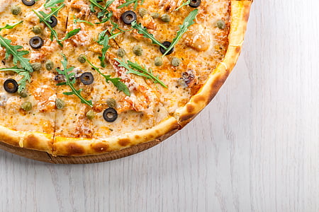 brown pizza on gray wooden board thumbnail