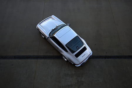 aerial photo of silver Porsche Carrera coupe thumbnail