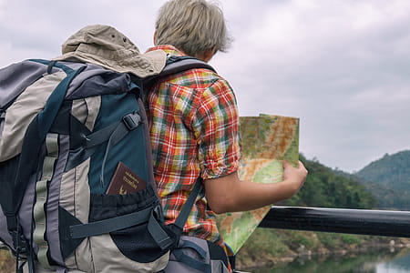 Man Holding Green and Brown Map thumbnail
