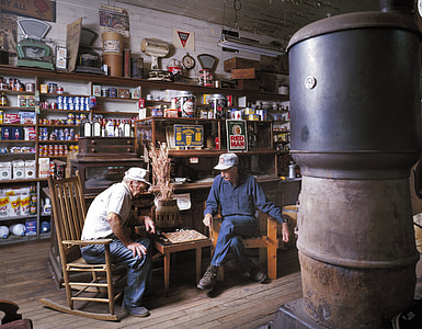 two men sitting on brown chair while playing chess thumbnail
