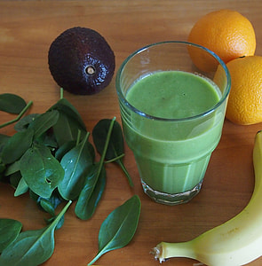 half-full vegetable shake filled drinking cup beside assorted fruits thumbnail
