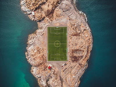 bird's eye photography of island with soccer field in the middle thumbnail