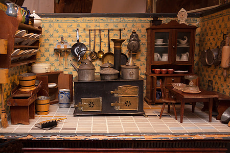 brown wooden display cabinet; black wooden side table; assorted kitchen utensils thumbnail