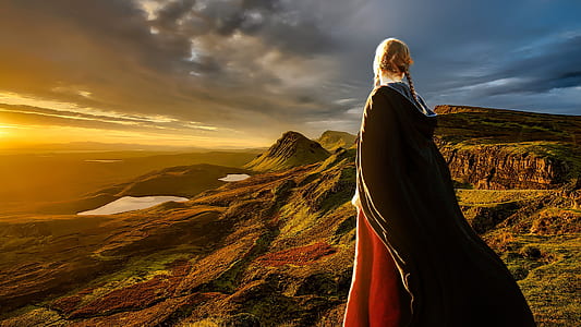woman wearing red dress and black cape standing during daytime thumbnail