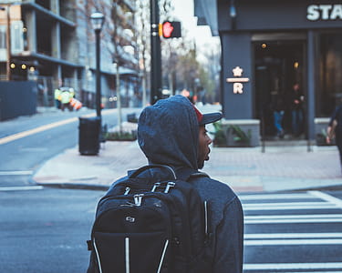 Person Wearing Black Backpack About to Cross Pedestrian thumbnail
