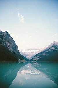 blue lake beside white mountains during daytime thumbnail