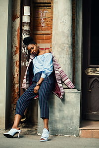 Woman Sitting on Concrete Column thumbnail