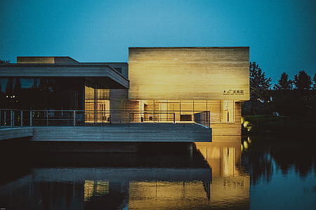 lighted house on body of water thumbnail