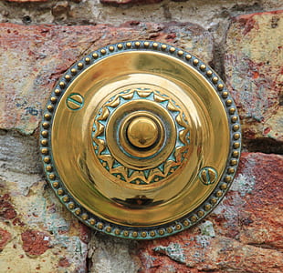 round brass wall ornament on wall thumbnail