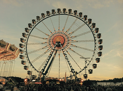 people walking beside black and brown ferris wheel during daytime thumbnail