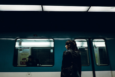 woman in black coat near train thumbnail