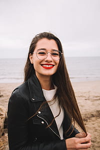 smiling woman standing by the beach during daytime thumbnail