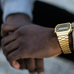 Person Wearing Gold-colored Casio Digital Watch With Linked Strap thumbnail