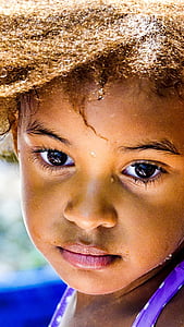 close-up photography of child with purple and white sleeveless top thumbnail
