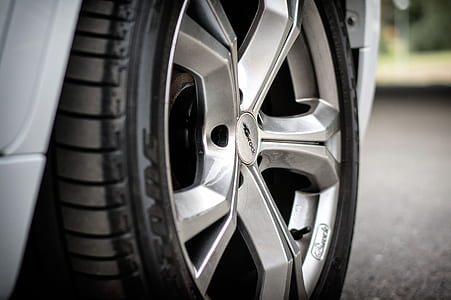 silver 5-lug automotive wheel with tire thumbnail