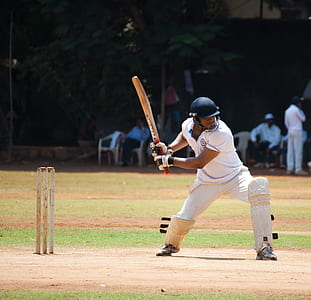 man playing cricket on field during daytime thumbnail