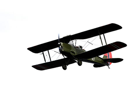 Green and Black Propeller Plane Flying Under Clear Sky thumbnail