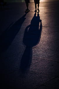 two person walking outdoors showing shadows thumbnail