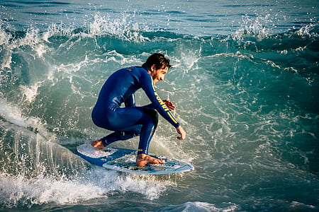 man riding surfboard on water wave thumbnail