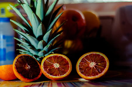 sliced blood orange fruits and pineapples on table thumbnail