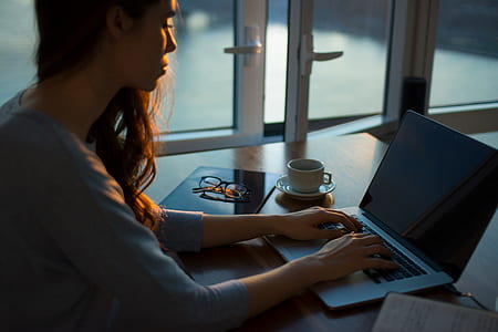 woman facing in front of laptop computer thumbnail