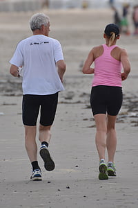 man in white top jogging beside woman in pink racerback top thumbnail