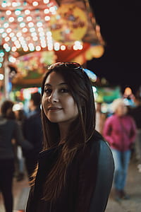 selective focus photo of woman with lots of bright lights on her background thumbnail