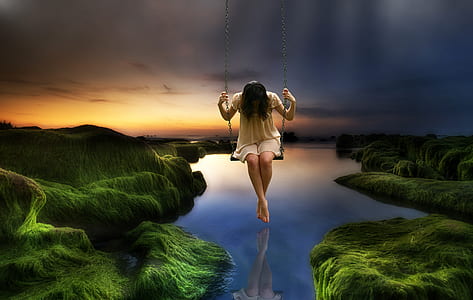 woman on swing with lake on the background thumbnail