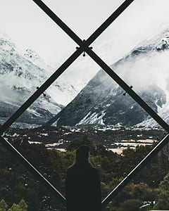 person standing while watching view of mountain at daytime thumbnail