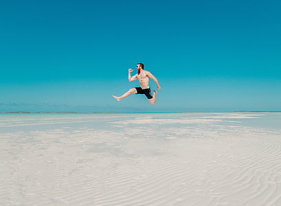jumping man against seashore thumbnail