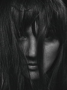 woman with black hair covering her face thumbnail