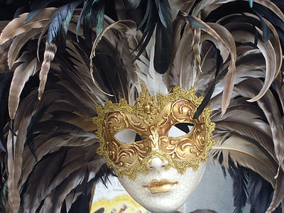 closeup photo of brown and gold feather masquerade mask thumbnail
