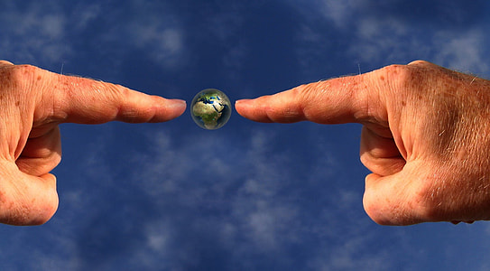 person pointing on earth digital wallpaper thumbnail