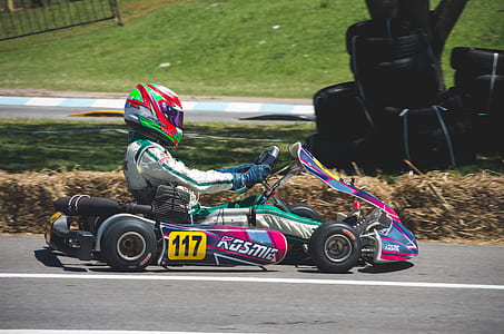 Man In Racing Suit With Helmet Riding Go Kart thumbnail