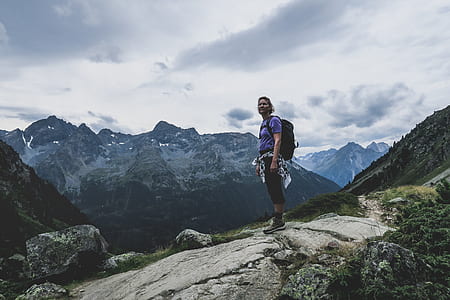 person standing on top of mountain during daytime thumbnail