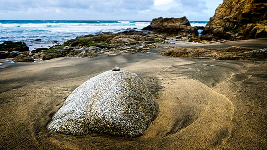 high angle photo of rock on seashore thumbnail