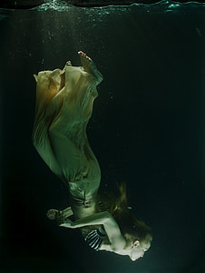 woman diving through the water thumbnail