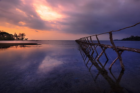 brown wooden dock on calm body of water thumbnail