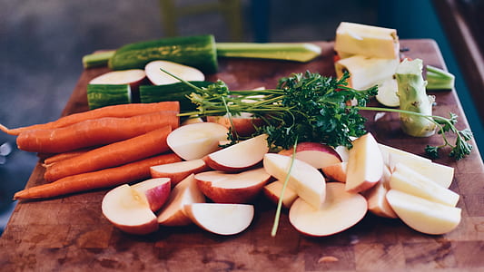 sliced fruits and vegetable on chopping board thumbnail