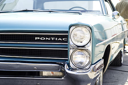 closeup photo of teal Pontiac car thumbnail