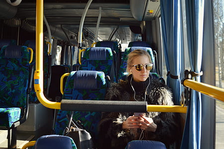 woman sitting on chair inside bus wearing sunglasses thumbnail