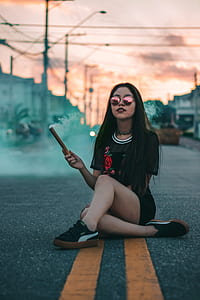 Woman In Black Crew-neck T-shirt Sitting On Concrete Roadway thumbnail