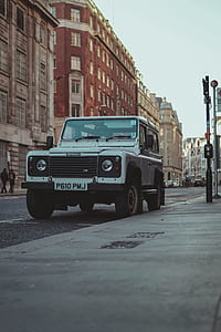 white SUV parked beside pavement thumbnail