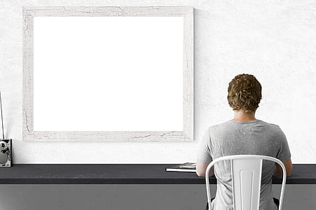 person sitting on white metal chair thumbnail