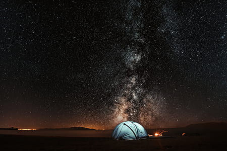 blue camping tent on desert during daytime thumbnail
