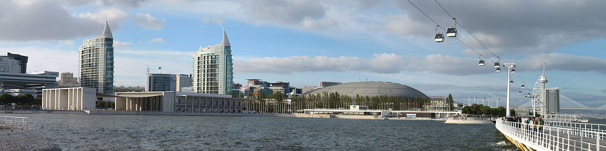 gray concrete buildings near ocean thumbnail